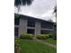 Two-story condo building featuring well-maintained landscaping and neutral color palette at 2548 Oak Park Way # 102, Orlando, FL 32822