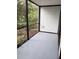 Enclosed lanai offers a serene space for outdoor living and enjoyment of surrounding greenery at 2548 Oak Park Way # 102, Orlando, FL 32822
