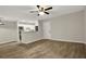Open-concept living space with sleek wood-look flooring, flowing into the kitchen area at 2548 Oak Park Way # 102, Orlando, FL 32822