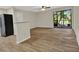 Spacious living area with wood-look flooring and access to a screened lanai with peaceful views at 2548 Oak Park Way # 102, Orlando, FL 32822