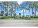 Street view of a community lot with tall trees, offering serene privacy and natural beauty at 2548 Oak Park Way # 102, Orlando, FL 32822