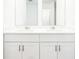 Bathroom featuring dual sinks, white cabinets, and neutral countertops at 2917 Wild Olive Dr, St Cloud, FL 34772