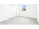 Bedroom with carpet, closet, and a window overlooking trees at 2917 Wild Olive Dr, St Cloud, FL 34772