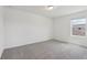 Minimalist bedroom featuring soft carpeting and a large window offering natural light at 2917 Wild Olive Dr, St Cloud, FL 34772