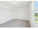 Bright bedroom with plush carpeting, a large window offering natural light, and closet at 2917 Wild Olive Dr, St Cloud, FL 34772