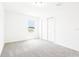 Bright, carpeted bedroom with a window for natural light and closet with sliding doors at 2917 Wild Olive Dr, St Cloud, FL 34772