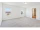 Well-lit bedroom with carpet, two windows, and a glimpse into the closet at 2917 Wild Olive Dr, St Cloud, FL 34772