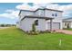 A well-kept lawn highlights this home's two-car garage, neat landscaping, and neutral exterior at 2917 Wild Olive Dr, St Cloud, FL 34772