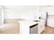 Modern kitchen with a large island, stainless steel appliances and wood-look tile flooring at 2917 Wild Olive Dr, St Cloud, FL 34772