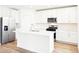 Modern kitchen features an island, stainless steel appliances, and white cabinets at 2917 Wild Olive Dr, St Cloud, FL 34772
