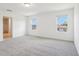 Bright bedroom featuring large windows and neutral carpet at 2925 Wild Olive Dr, St Cloud, FL 34772