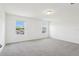 Bright bedroom featuring large windows and neutral carpet at 2925 Wild Olive Dr, St Cloud, FL 34772
