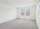 Bright bedroom featuring large windows and neutral carpet at 2925 Wild Olive Dr, St Cloud, FL 34772
