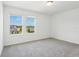 Bright bedroom featuring large windows and neutral carpet at 2925 Wild Olive Dr, St Cloud, FL 34772