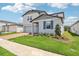 Charming two-story home with a well-manicured lawn and brick paver driveway at 2925 Wild Olive Dr, St Cloud, FL 34772