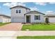 Charming two-story home with a well-manicured lawn and brick paver driveway at 2925 Wild Olive Dr, St Cloud, FL 34772