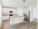 Modern kitchen featuring white cabinets, granite countertops, and stainless steel appliances at 2925 Wild Olive Dr, St Cloud, FL 34772