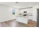 Bright kitchen features an island, granite countertops, stainless appliances, and white cabinets at 2925 Wild Olive Dr, St Cloud, FL 34772