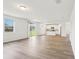 Open-concept living space with wood-look floors seamlessly connects to the modern kitchen at 2925 Wild Olive Dr, St Cloud, FL 34772