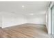 Bright, open living area with wood-look floors, with a door to the left and a view of the backyard at 2925 Wild Olive Dr, St Cloud, FL 34772