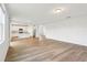 Open-concept living space with wood-look floors seamlessly connects to the modern kitchen at 2925 Wild Olive Dr, St Cloud, FL 34772