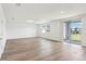 Bright, open living area with wood-look floors and sliding glass doors to the backyard at 2925 Wild Olive Dr, St Cloud, FL 34772