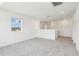 Upstairs loft with neutral carpet and natural light from an exterior window at 2925 Wild Olive Dr, St Cloud, FL 34772