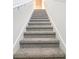 Carpeted staircase with a white railing leading to the upper level of the home at 2925 Wild Olive Dr, St Cloud, FL 34772