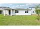 This home has a white exterior and an expansive backyard at 2929 Wild Olive Dr, St Cloud, FL 34772