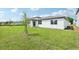 This home has a white exterior and an expansive backyard at 2929 Wild Olive Dr, St Cloud, FL 34772