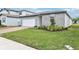 Charming single-Gathering home featuring well-manicured lawn, brick driveway, and modern gray siding at 2929 Wild Olive Dr, St Cloud, FL 34772