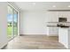 Open-concept kitchen with island and view of backyard through large sliding glass doors at 2929 Wild Olive Dr, St Cloud, FL 34772