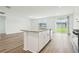 Well-lit kitchen with a central island, sleek appliances, and a sliding glass door to the backyard at 2929 Wild Olive Dr, St Cloud, FL 34772