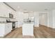 Contemporary kitchen featuring white cabinets, stainless appliances, and island with granite countertops at 2929 Wild Olive Dr, St Cloud, FL 34772