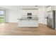 Bright kitchen features a central island, modern appliances, sleek flooring, and seamless transition to living area at 2929 Wild Olive Dr, St Cloud, FL 34772