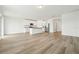 Open-concept living area with stylish flooring, white walls, and a modern kitchen island for entertaining at 2929 Wild Olive Dr, St Cloud, FL 34772