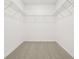 Walk-in closet features neutral carpet, shelving, and white walls at 2929 Wild Olive Dr, St Cloud, FL 34772