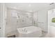 Bright bathroom featuring a soaking tub with glass surround and tiled shower at 3347 Hanging Tide St, Winter Garden, FL 34787