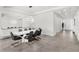 Contemporary dining room featuring a modern light fixture, white walls, tile floor and seating for six at 3347 Hanging Tide St, Winter Garden, FL 34787