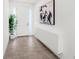 Bright entryway featuring white walls, a modern cabinet, stylish artwork, and a view of the front door at 3347 Hanging Tide St, Winter Garden, FL 34787