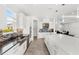Bright kitchen with stainless steel appliances, stone backsplash, and large island with a quartz countertop at 3347 Hanging Tide St, Winter Garden, FL 34787