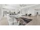 Expansive living room with a large couch, area rug, and an open layout that connects to the kitchen at 3347 Hanging Tide St, Winter Garden, FL 34787