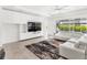 Bright living room with a built-in entertainment center and large glass doors leading to an outdoor area at 3347 Hanging Tide St, Winter Garden, FL 34787