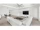Large living room with white couch, entertainment center, tile floors, and open access to the dining area at 3347 Hanging Tide St, Winter Garden, FL 34787