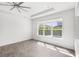 Bright living area featuring large windows and neutral colors throughout at 3347 Hanging Tide St, Winter Garden, FL 34787