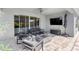 Covered patio with a ceiling fan, outdoor seating, fireplace, and entertainment area at 3347 Hanging Tide St, Winter Garden, FL 34787