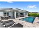 Inviting backyard oasis featuring a sparkling pool, covered patio, outdoor dining area, and comfortable lounge chairs at 3347 Hanging Tide St, Winter Garden, FL 34787