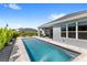 Inviting backyard pool featuring a covered patio and beautiful landscaping at 3347 Hanging Tide St, Winter Garden, FL 34787