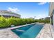 Backyard swimming pool with patio and outdoor seating, surrounded by privacy landscaping at 3347 Hanging Tide St, Winter Garden, FL 34787
