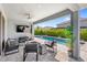 Covered patio with a view of the pool, outdoor seating, and a lush landscape at 3347 Hanging Tide St, Winter Garden, FL 34787